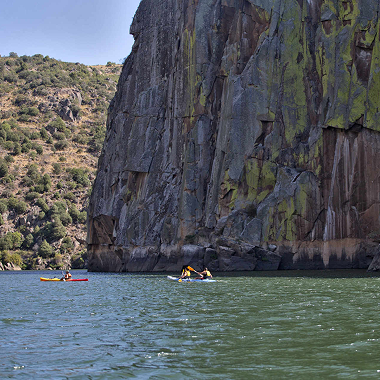 Kayakers paddling along cliffs in Douro International Natural Park